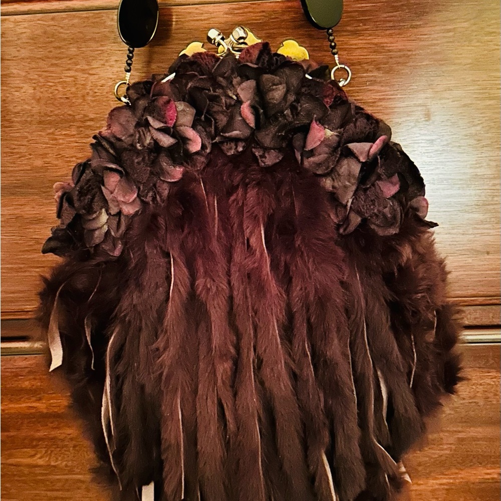 Handcrafted evening bag with a beaded handle and fur fringe adorned-flowers